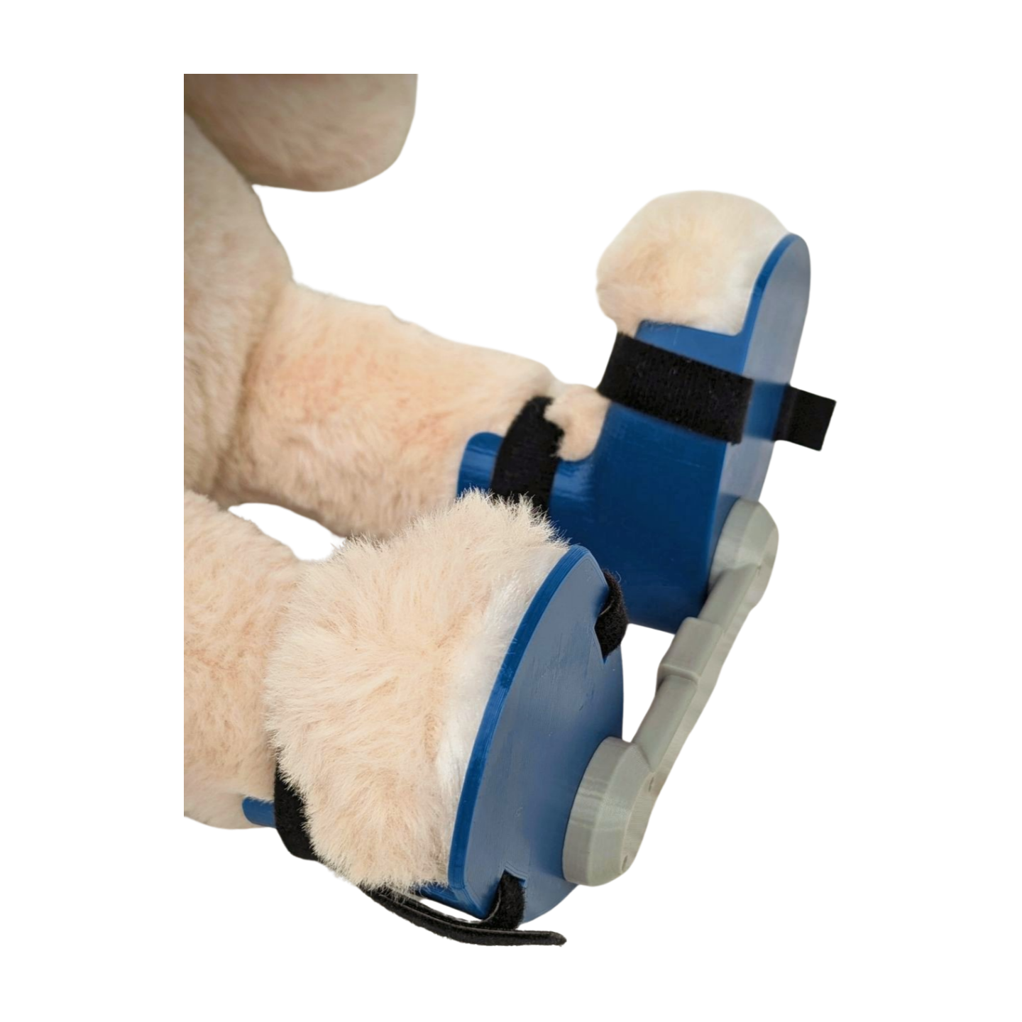 Close-up view of blue clubfoot boots and bar brace on a stuffed bunny, modeled after Ponseti braces.
