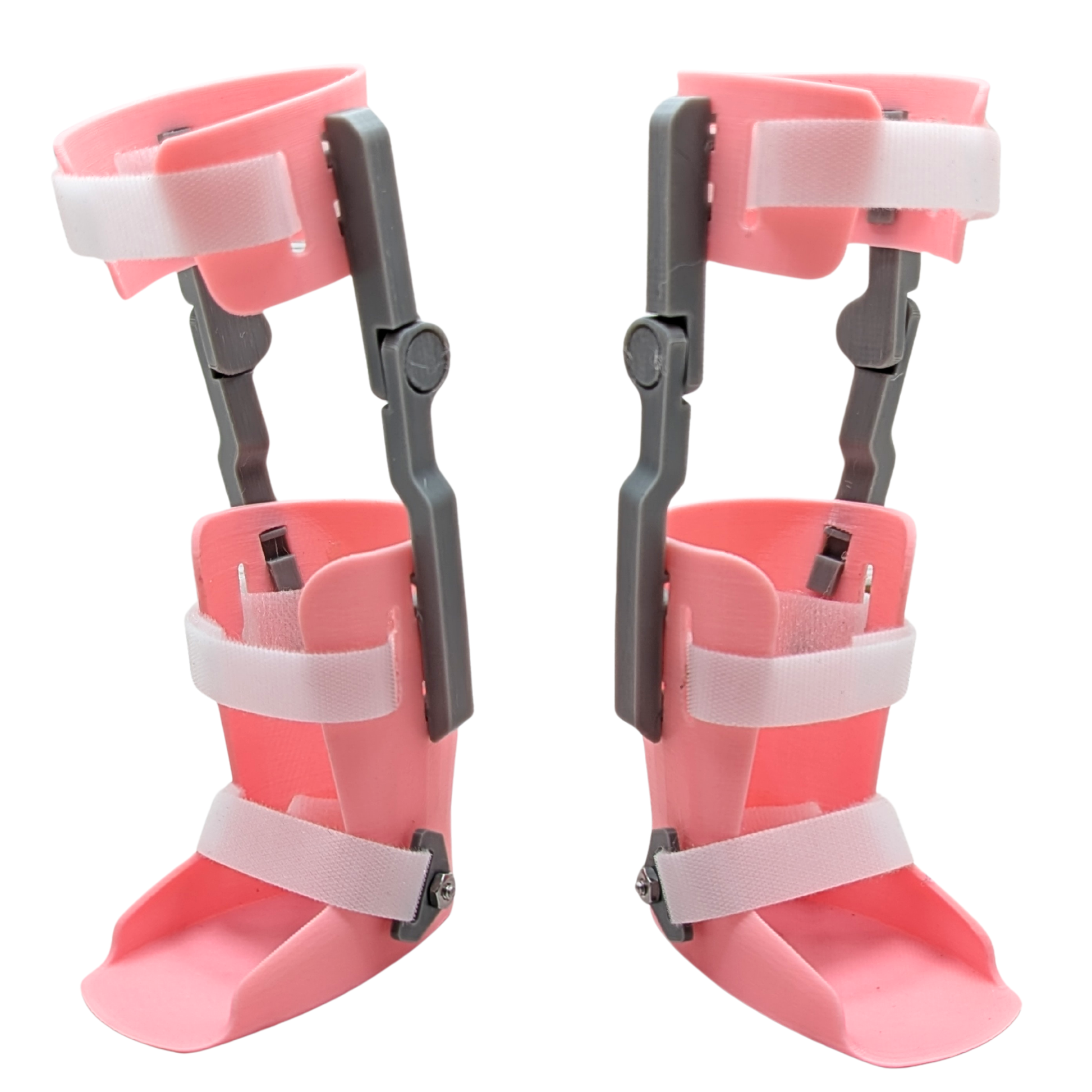 Doll-sized KAFO leg braces designed for 18-inch dolls, white Velcro straps and gray alignment guides.